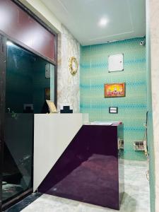 a desk in a room with a purple and white at Hotel Maatrika and banquets in Orchha