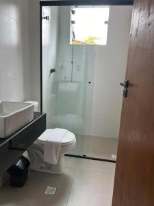 a bathroom with a toilet and a sink and a shower at Pousada do Francês in Ubatuba +50 photos