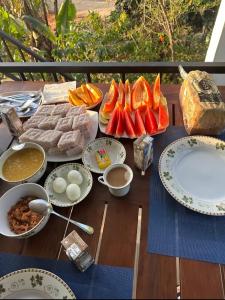 a table with food and plates of food on it at Rasal Homestay in Ella +7 photos