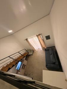an empty room with a couch and a window at Apartamentos Aledu in Brasilito