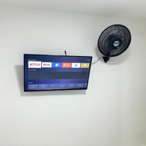 a television and a fan on a white wall at Hotel Zona Oro in Armenia +20 photos