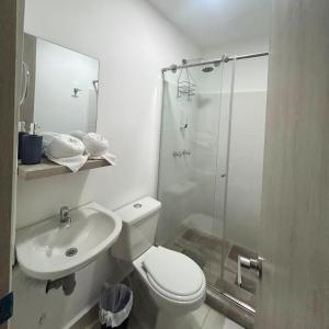 a bathroom with a toilet and a shower and a sink at Hotel Zona Oro in Armenia