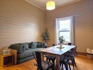a living room with a couch and a table at Cosy Cottage in Port Broughton