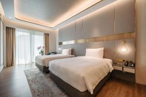 a hotel room with two beds and a large window at Resorts World Sentosa - Crockfords Tower in Singapore