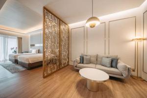 a living room with a couch and a bed and a mirror at Resorts World Sentosa - Crockfords Tower in Singapore +25 photos