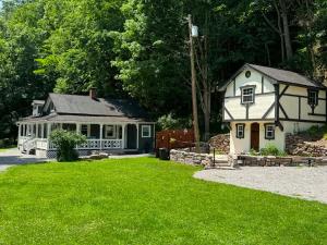a white house and a house with a yard at The Renovated Farmhouse at Seneca Rocks in Seneca Rocks