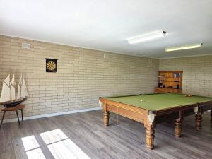 a room with a pool table and a clock on the wall at 38 at Point Turton in Point Turton
