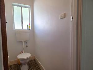 a bathroom with a toilet and a window at 38 at Point Turton in Point Turton +12 photos