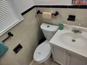 a bathroom with a white toilet and a sink at Modern studio in a prime location 112-1 in Hollywood +12 photos