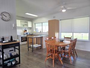a kitchen and dining room with a table and chairs at 38 at Point Turton in Point Turton