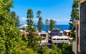 a city with trees and the ocean in the background at Ocean Tracks in Kiama