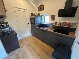 a kitchen with a sink and a counter top at Tim's Place in Groesbeek +2 photos