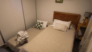 a bedroom with a bed with two pillows on it at Lomajobava in Godoy Cruz +9 photos
