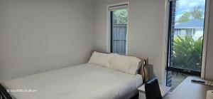 a small bedroom with a bed and a window at Serene Home in Bahrs Scrub