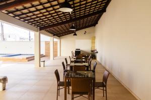a dining room with tables and chairs in a building at Ap do Maro in Barreirinhas