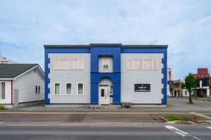 a blue and white house on the side of a street at Snowm in Asahikawa