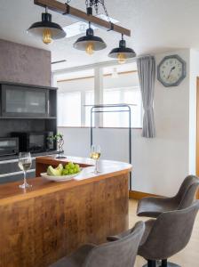 a kitchen with a counter with two glasses of wine at Snowm in Asahikawa
