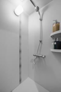 a shower with a shower head in a bathroom at Snowm in Asahikawa