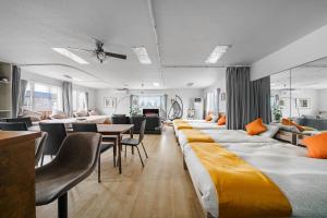 a room with many beds and a dining room at Snowm in Asahikawa +60 photos