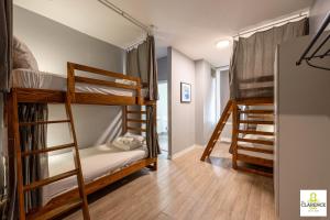 a room with three bunk beds and a hallway at The Clarence Park in Toronto +80 photos