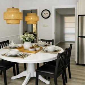 a dining room with a white table and chairs at The Nest in Bidwill