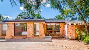 a brick house with a brick driveway at The Nest in Bidwill