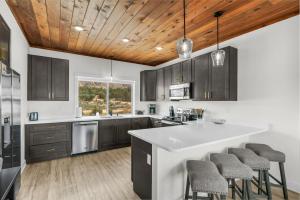 a kitchen with a white counter top and wooden ceilings at Painted Cliffs-Hot Tub, Amazing Views Between Zion and Bryce in Orderville