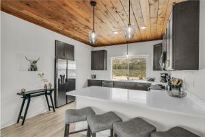 a kitchen with a white counter and wooden ceilings at Painted Cliffs-Hot Tub, Amazing Views Between Zion and Bryce in Orderville +28 photos