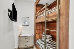 a bedroom with a bunk bed and a tv at Painted Cliffs-Hot Tub, Amazing Views Between Zion and Bryce in Orderville