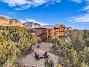 an image of a cabin in the mountains with two chairs at Painted Cliffs-Hot Tub, Amazing Views Between Zion and Bryce in Orderville