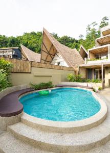 a swimming pool in the backyard of a house at Panorama Villas & Suites El Nido in El Nido