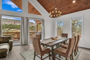 a dining room with a table and chairs at Copper Rock Ridge- Luxury, Pool Table, Hot Tub between Zion and Bryce in Orderville