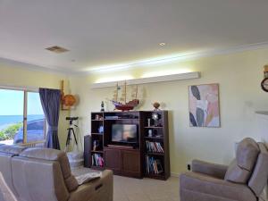 a living room with a couch and a tv at Willenby in Wallaroo
