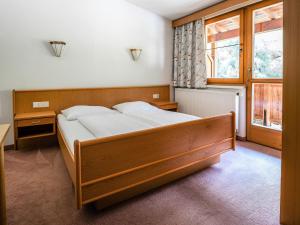 a bedroom with a bed and a large window at Chalet in Angerberg near SkiWelt Slopes in Angerberg