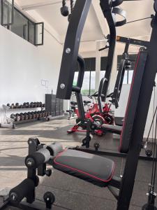 a gym with a lot of treadmills and weights at Serenity Spot - Cozy 1 bedroom with AC and Heater with City View in Nairobi, Westlands in Nairobi