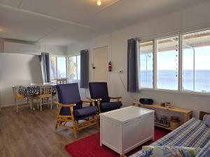 a room with chairs and a table and a dining room at Jack's Shack in Pine Point