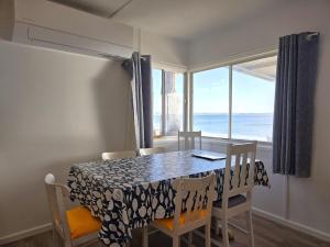a dining room with a table and chairs and a window at Jack's Shack in Pine Point