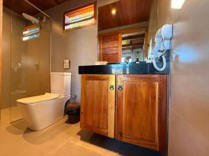 a bathroom with a toilet and a sink at Corumbau Bangalôs in Corumbau +23 photos