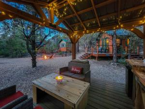 a wooden patio with a table and a playground at Live Simply Cabin, Walking distance to East Zion trails in Orderville
