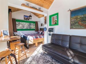 a living room with a couch and a bed at Live Simply Cabin, Walking distance to East Zion trails in Orderville