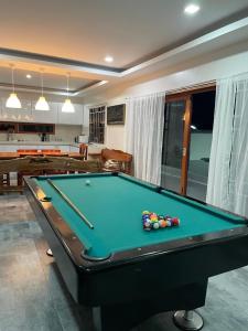 a pool table in a living room with a pool table at Norwil Manor Tagaytay in Tagaytay
