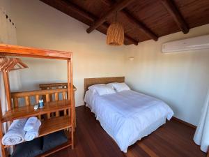 a bedroom with a bed and a bunk bed at Corumbau Bangalôs in Corumbau