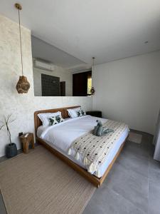 a bedroom with a large bed in a room at Makai Lombok in Selong Belanak +33 photos
