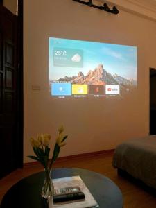 a tv screen on a wall in a room at Bee's House in Hanoi