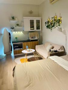 a living room with a bed and a couch and a table at Bee's House in Hanoi
