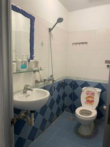 a bathroom with a toilet and a sink at Bee's House in Hanoi