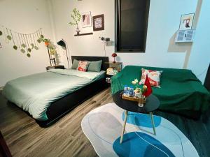 a bedroom with two beds and a table in it at Bee's House in Hanoi +11 photos