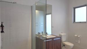 a bathroom with a toilet and a sink and a shower at Beach & Bubbles in Port Moonta +17 photos