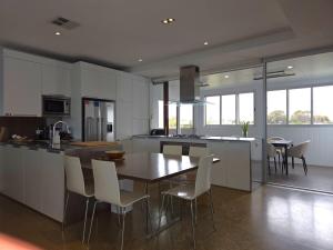 a kitchen with a table and chairs in a room at Beach & Bubbles in Port Moonta