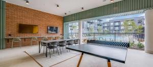 a room with tables and chairs and a large window at Landing Chic 3BD Clubhouse Pool in Denton